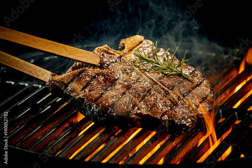 Grilling a tasty tender t-bone steak on the fire