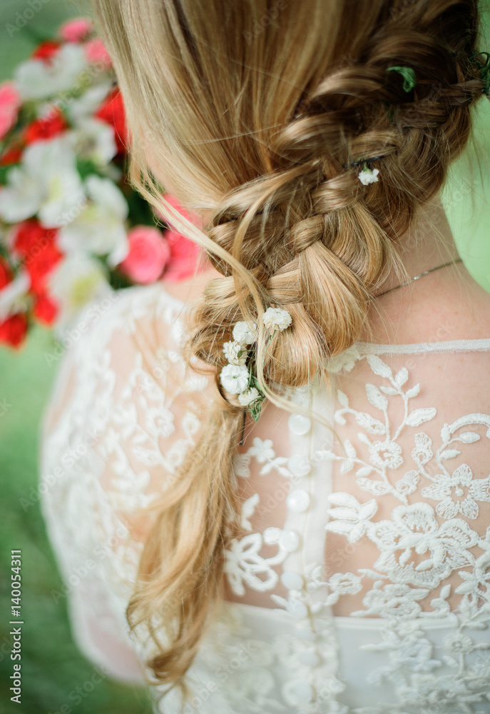Look from behind at braid of bride's blonde hair Look from behind at braid of bride's blonde hair