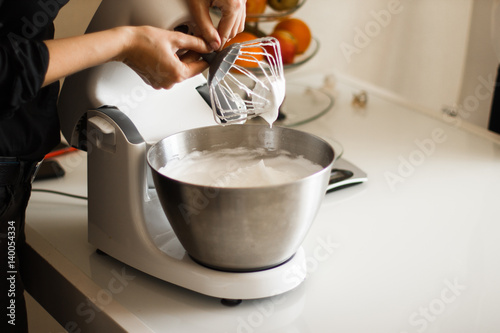 Making of a cream for home-made cakes on a mixer.