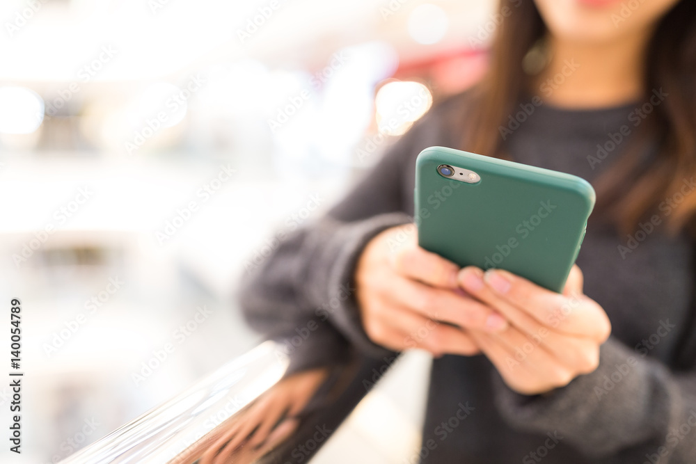 Woman sending sms on mobile phone Woman sending sms on mobile phone