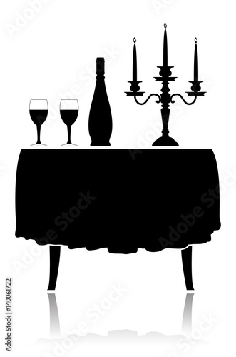 Silhouette romantic restaurant table with tablecloth, wine glasses, wine and candelabrum.