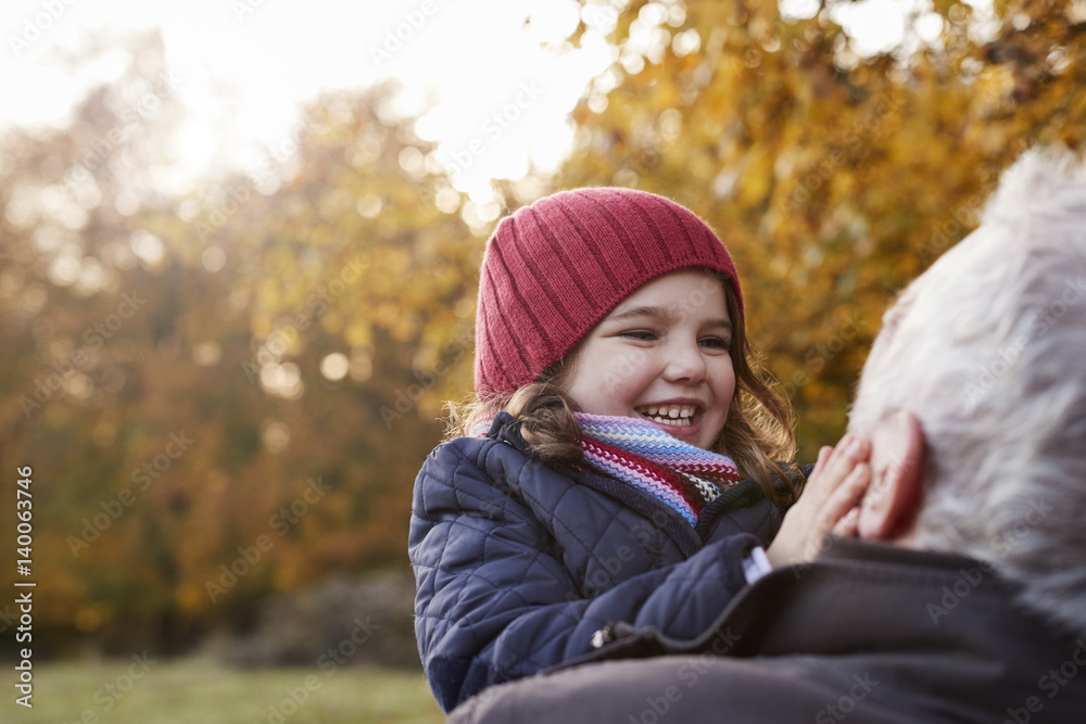 Grandfather Cuddling Granddaughter On Autumn Walk Grandfather Cuddling Granddaughter On Autumn Walk
