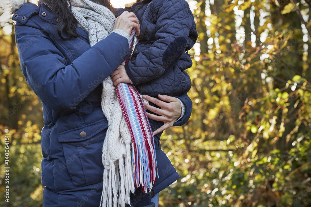 Fototapeta premium Mother Cuddling Daughter On Walk In Autumn Countryside