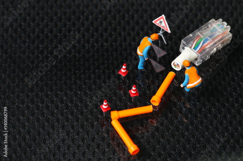 The damaged lan connection cable plug and maintenance figure miniature model represent the computor business and technology concept related idea. 