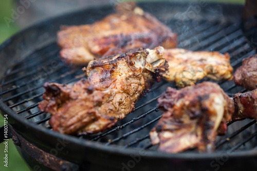 Cooking grilled red meat on barbeque