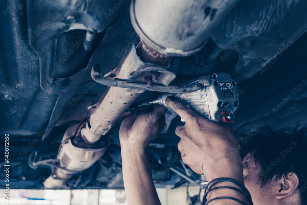 Obraz premium car service, repair, maintenance concept - auto mechanic man working at workshop