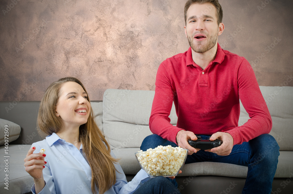 Couple enjoys free time and playing video games. Couple enjoys free time and playing video games.