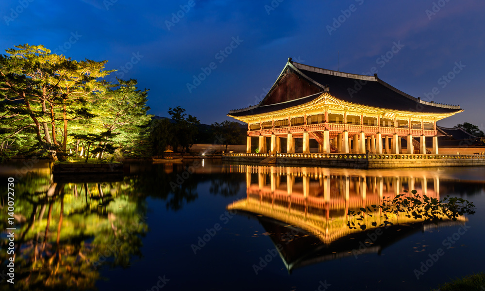 Gyeongbokgung Palace At Night In South Korea, with the name of the palace 'Gyeongbokgung' on a sign Gyeongbokgung Palace At Night In South Korea, with the name of the palace 'Gyeongbokgung' on a sign