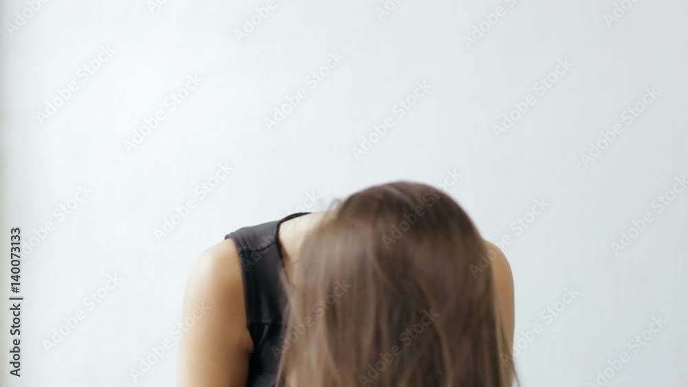 Attractive woman tossing hair on white background, slow motion Attractive woman tossing hair on white background, slow motion