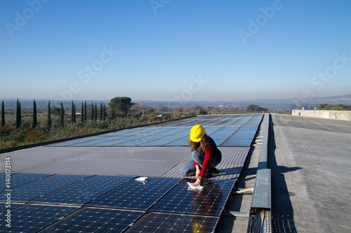 Wallpaper Mural young girl and elderly man cleaning photovoltaic panels Torontodigital.ca