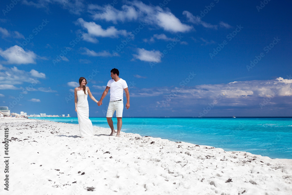 Young beautiful newlyweds on white sandy beach Young beautiful newlyweds on white sandy beach