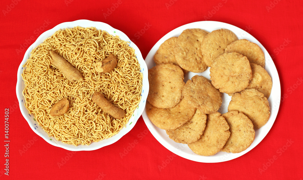Indian Mathari made with fine wheat flour and namkeen Bikaneri Bhujiya made with chickpea flour (Besan), popular Indian snacks Indian Mathari made with fine wheat flour and namkeen Bikaneri Bhujiya made with chickpea flour (Besan), popular Indian snacks