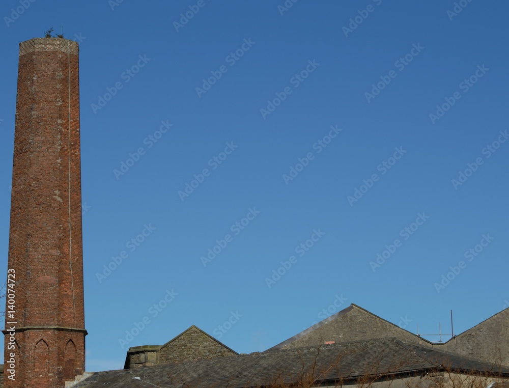 Old Mill Chimney against Blue Sky