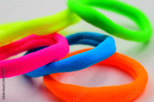 Some fluorescent elastics on white background. Tilt-shift effect applied.