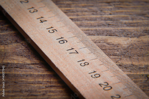  wooden ruler on wooden background photo