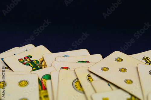 Italian suits playing cards with copy space. Tilt-shift effect applied.