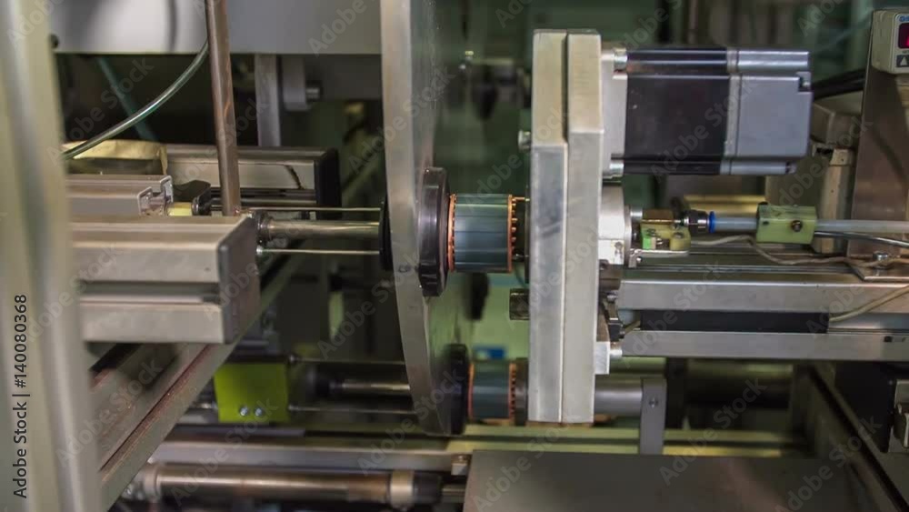 We can see the machine in the factory slowly moving. We can observe the production of small particles.
We can see the machine in the factory slowly moving. We can observe the production of small particles.