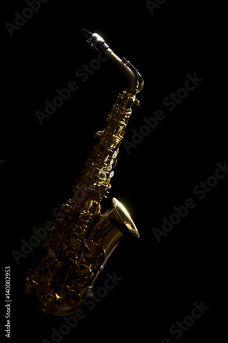 low key vintage alto saxophone and light in the dark background