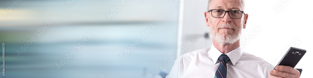 Portrait of businessman holding a mobile phone Portrait of businessman holding a mobile phone