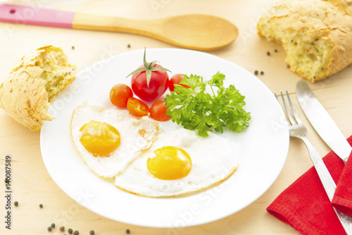 Fried Eggs on a plate on wooden background photo