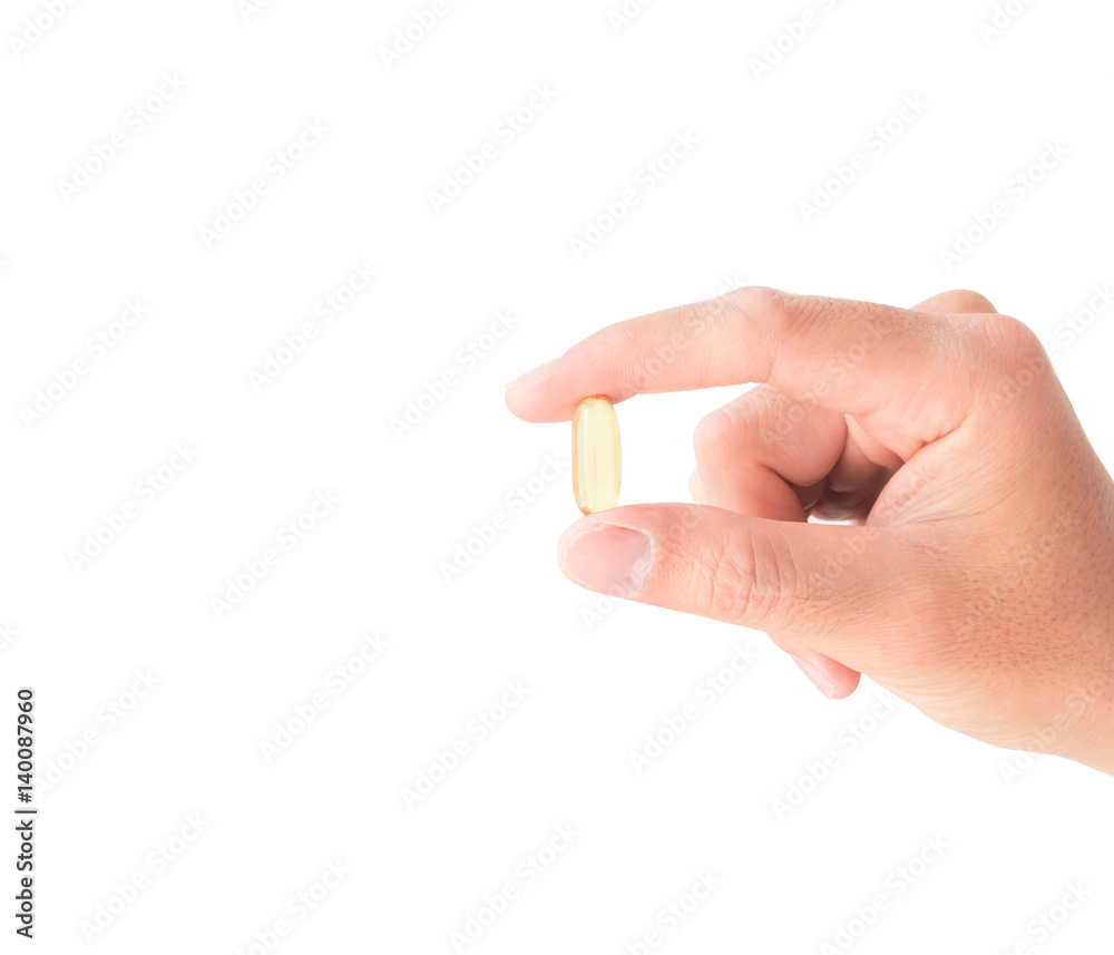 Hand holding fish oil medicine with white background Hand holding fish oil medicine with white background