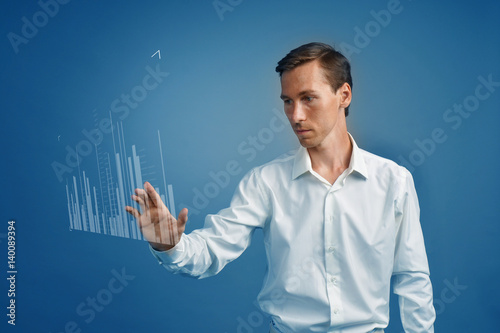 Finance data concept. Man working with Analytics. Chart graph information on digital screen.