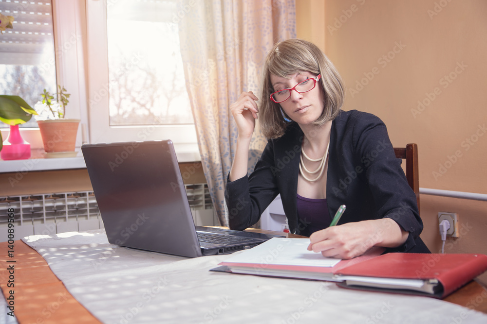 Happy corporate businesswoman writing down some stuff, filing paparework