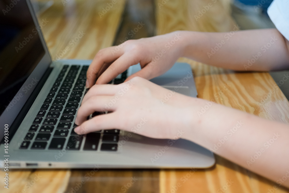Fototapeta premium Woman using computer laptop in coffee shop