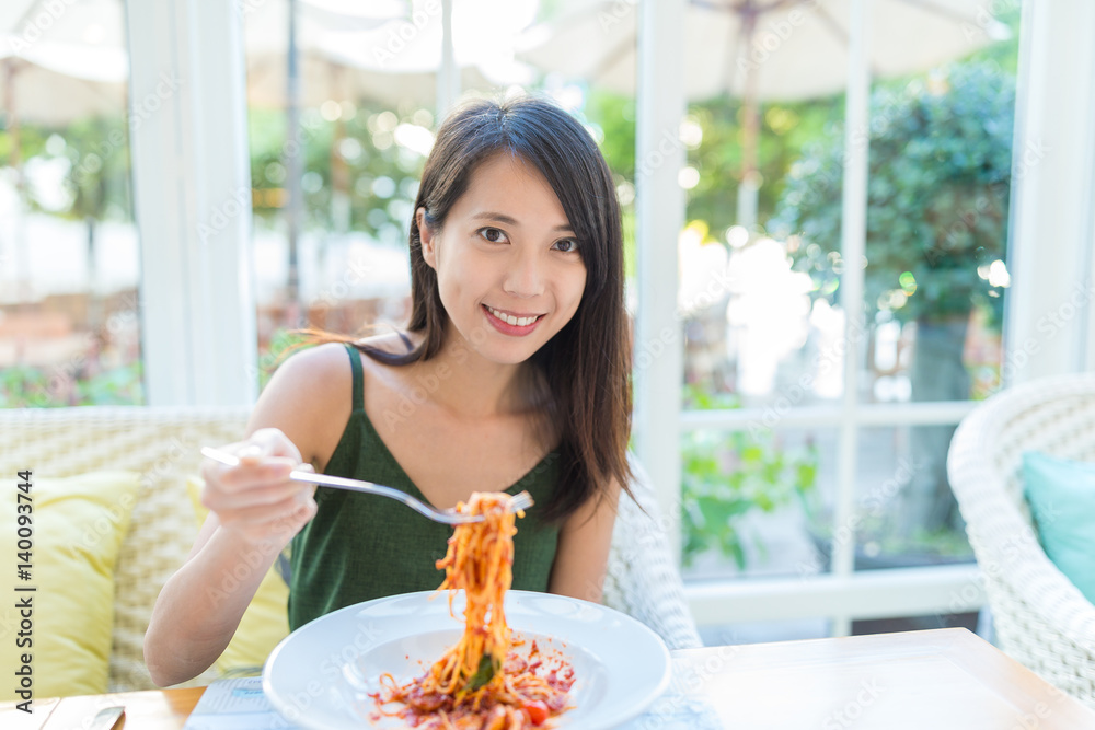 Woman having spaghetti in restaurant Woman having spaghetti in restaurant