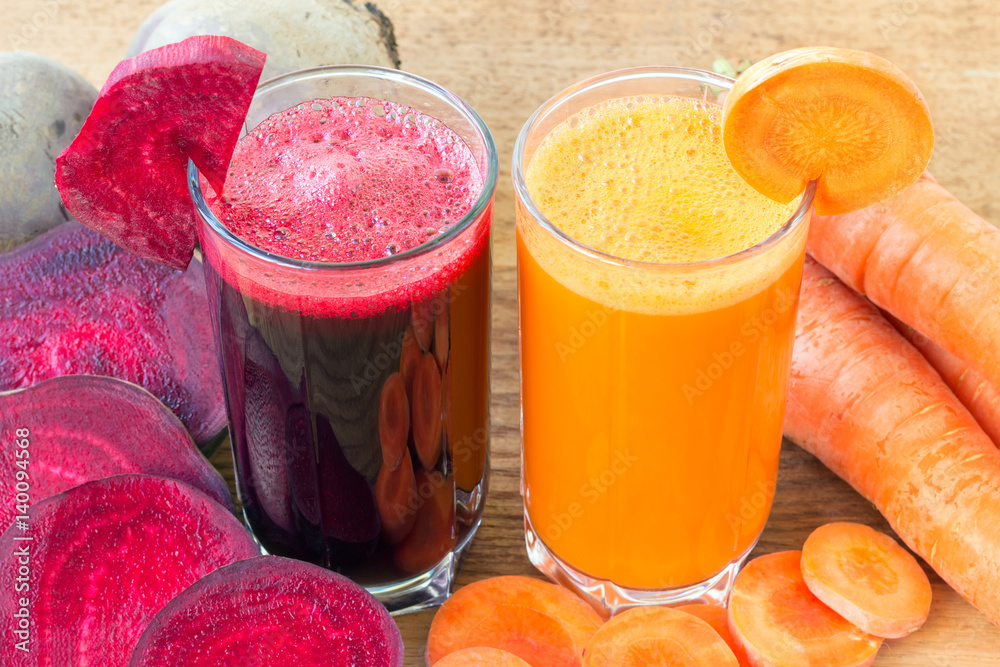Two glass of fresh beet and carrot juice, beetroot and carrots
