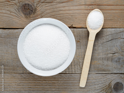 Sugar in bowl and spoon on table