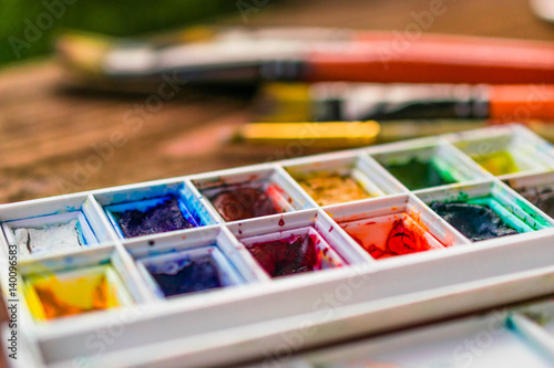 Closeup of messy, used water-color paint-box.Creative hobby concept photo