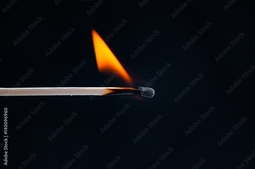 Burning match closeup on black background Burning match closeup on black background
