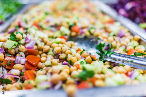 Photography Chickpea salad in tray in bar with spoon