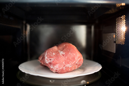 Frozen pork defrosted in the microwave