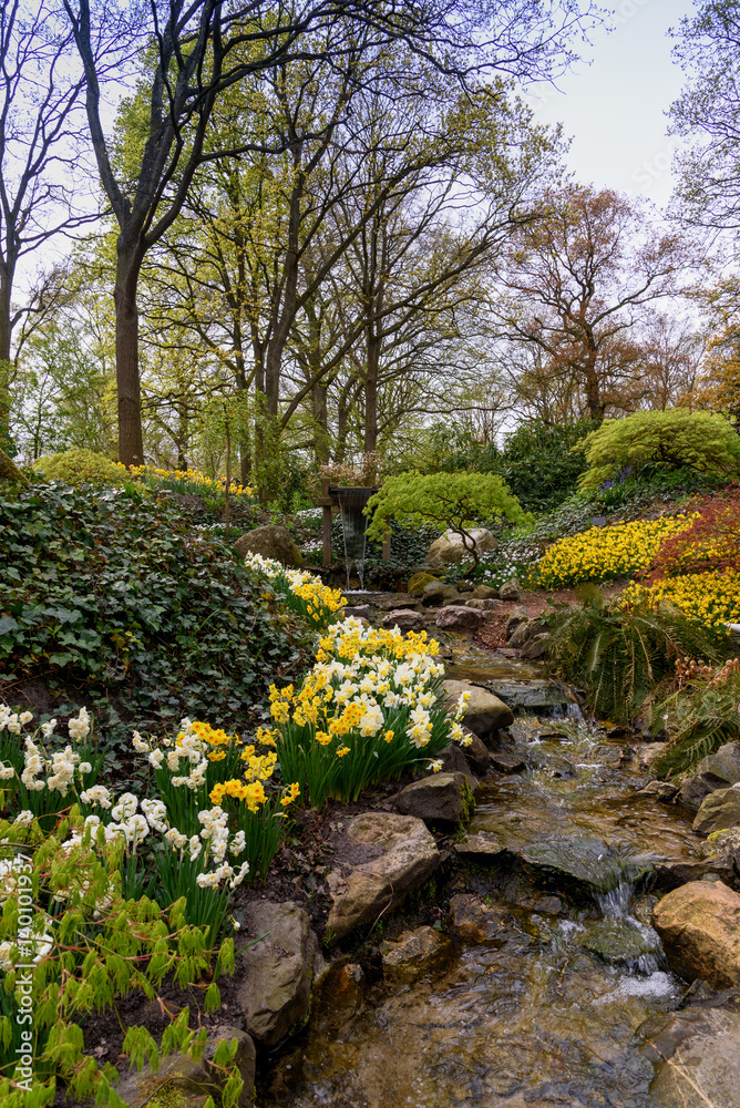 Landscape with a water creek. Keukenhof Gardens in the Netherlands Landscape with a water creek. Keukenhof Gardens in the Netherlands