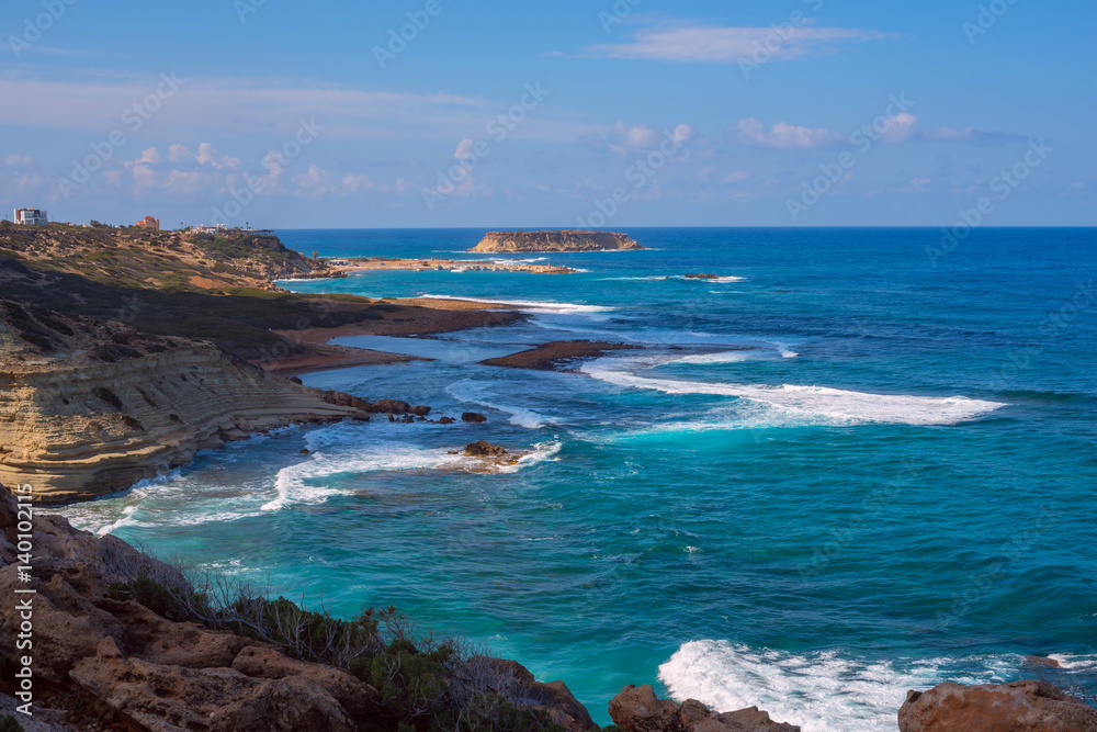 Wonderful seascape - blue waves splash near the rocky shore