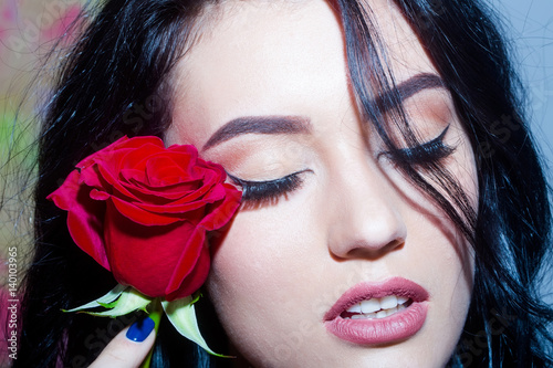 Pretty girl with closed eyes and red rose