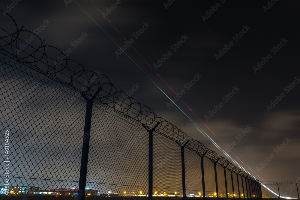 Fence with barbed wire, restricted area and starting plane 