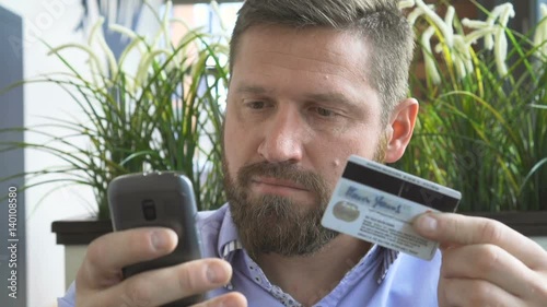 Businessman do online shopping by smartphone, credit card, steady close portrait