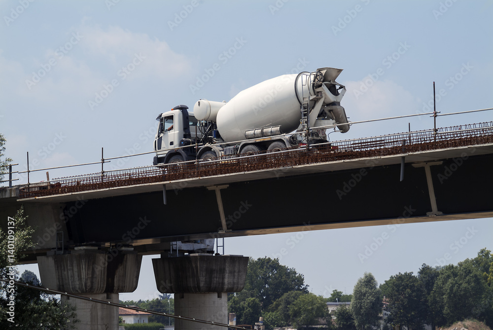 Cement mixer in transit on overpass under construction