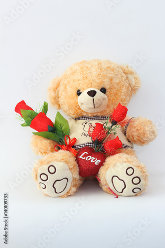 Brown teddy bears and red roses on a white background.