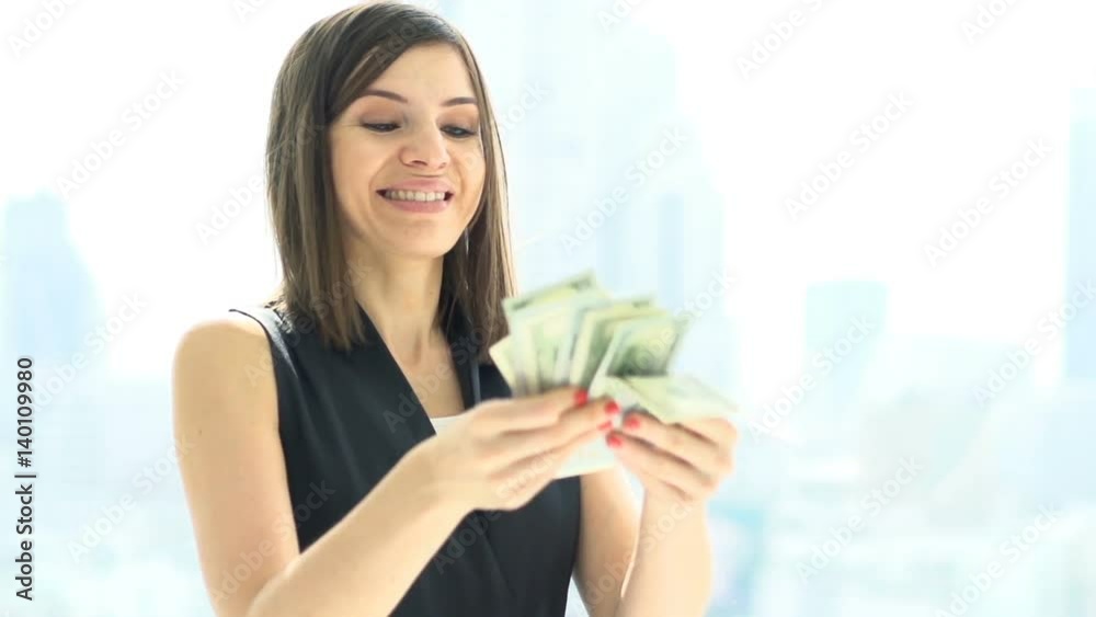 Happy, rich woman counting money standing by window at home, super slow motion 240fps
Happy, rich woman counting money standing by window at home, super slow motion 240fps