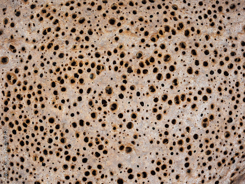 Traditional Ethiopean flatbread from fermented teff flour porous texture close-up