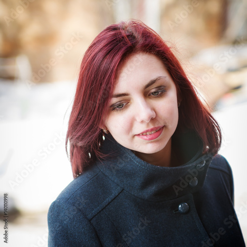 Portrait of a long-haired girl in a coat