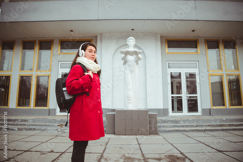 Young girl at university lisitng music photo