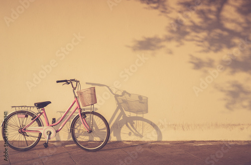 Bicycle parked at morning time beside the wall and shadow with area copy space © SKT Studio