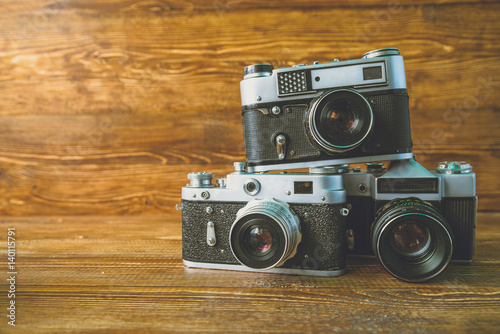 3 Vintage cameras on wooden background