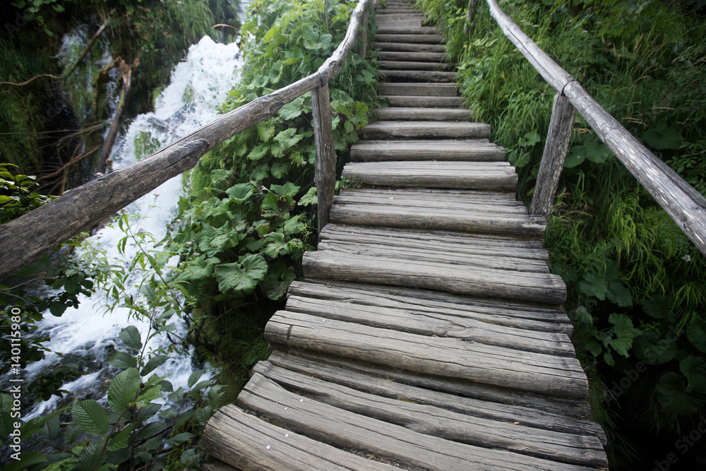 An old wooden staircase near a waterfall in a national park. Plitvice lakes. Croatia.
