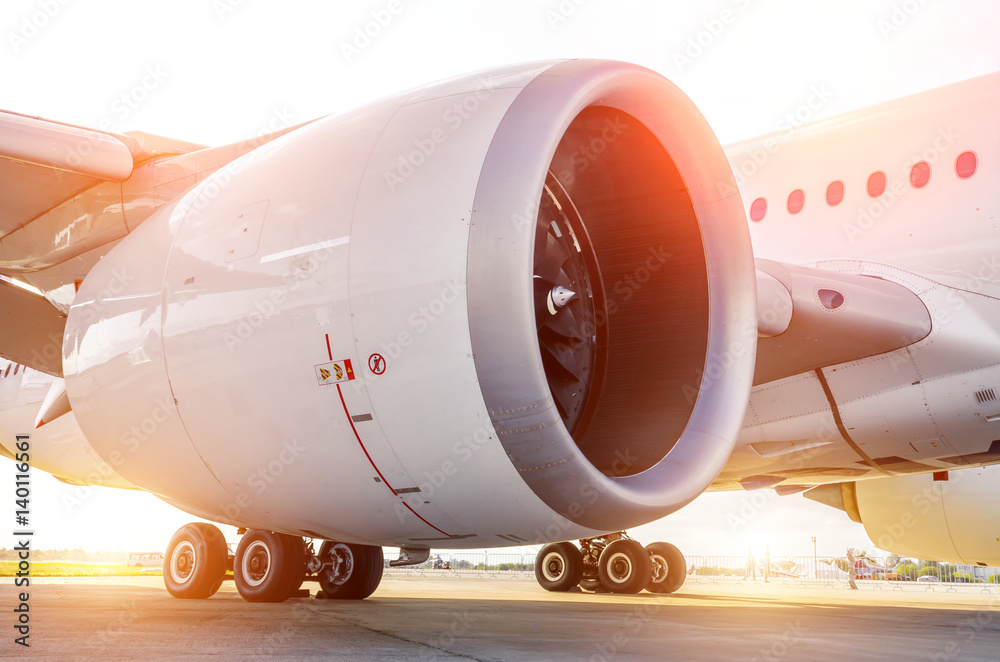 Large modern aircraft view of the huge engine and chassis, the light of the sun Large modern aircraft view of the huge engine and chassis, the light of the sun